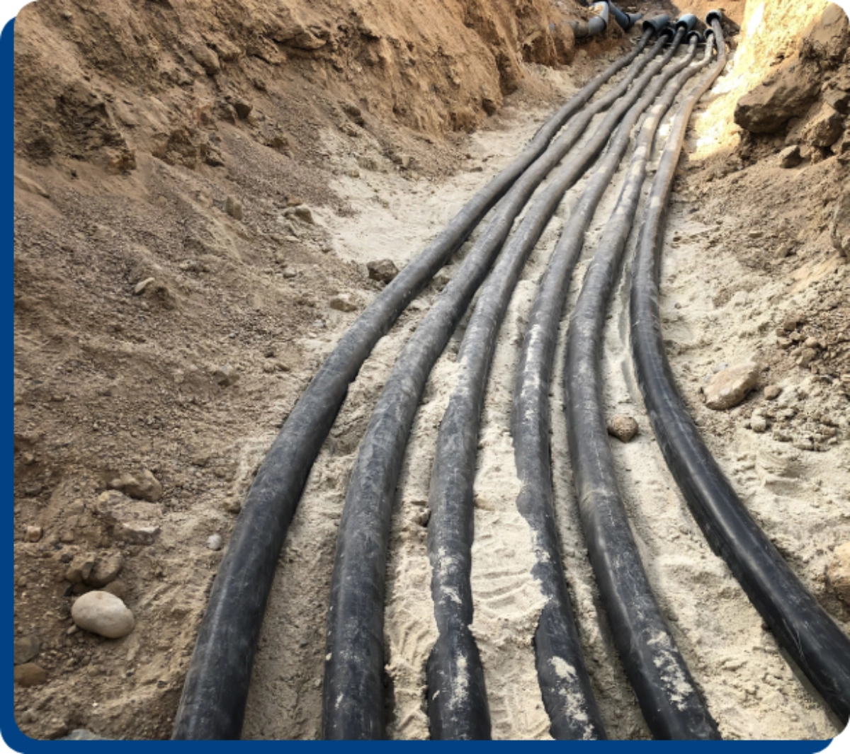 Here's an alt tag for the image: Underground conduit cables in trench.