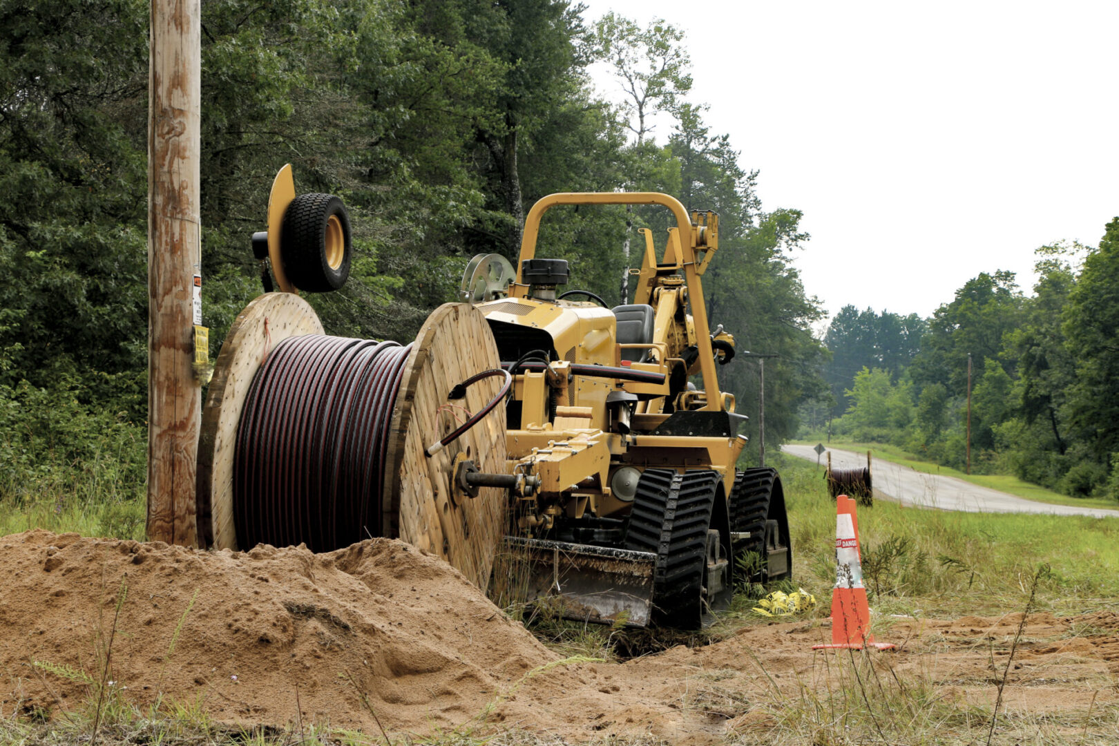 Cable laying machine with spool of wire.