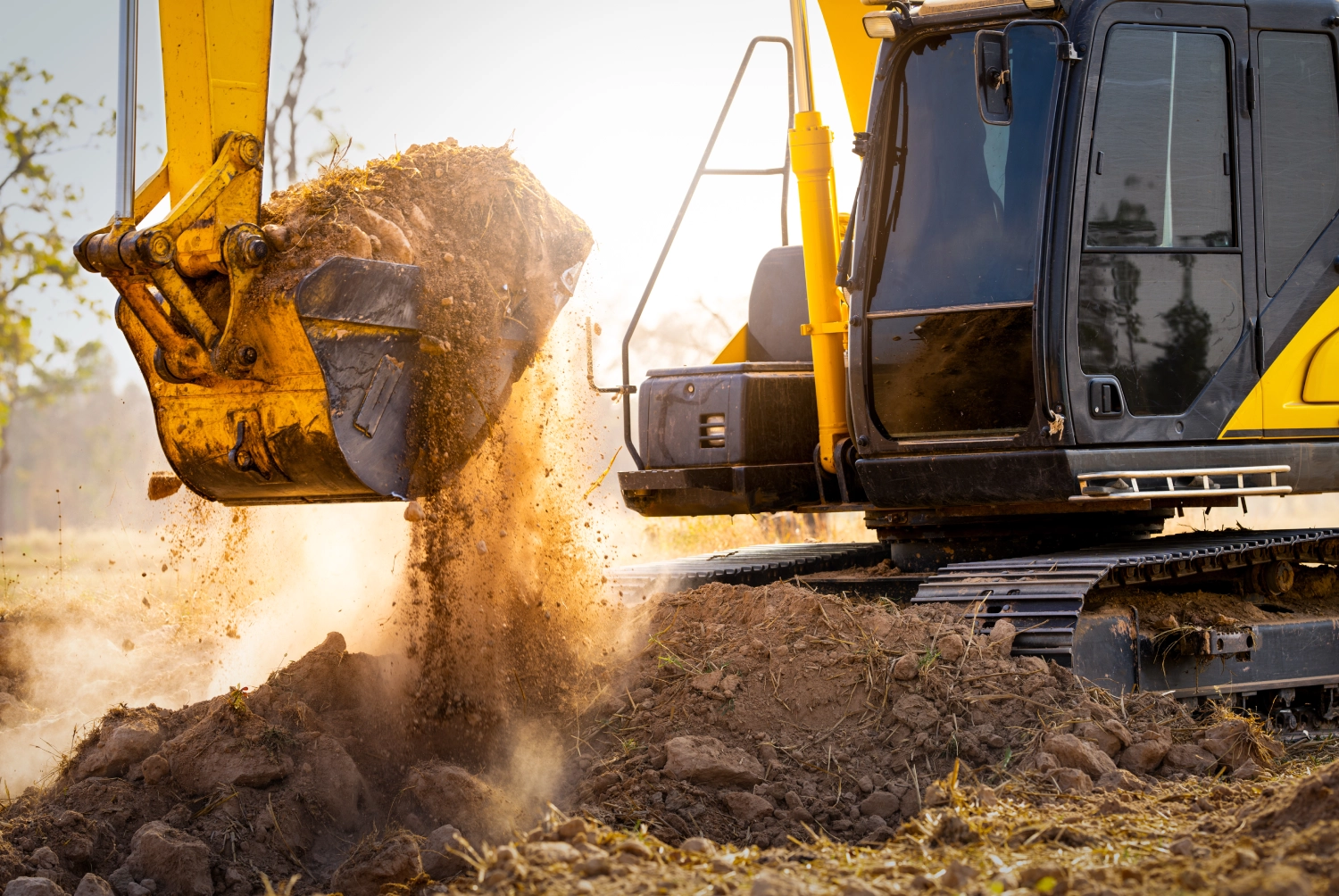 Excavator digging dirt at construction site.